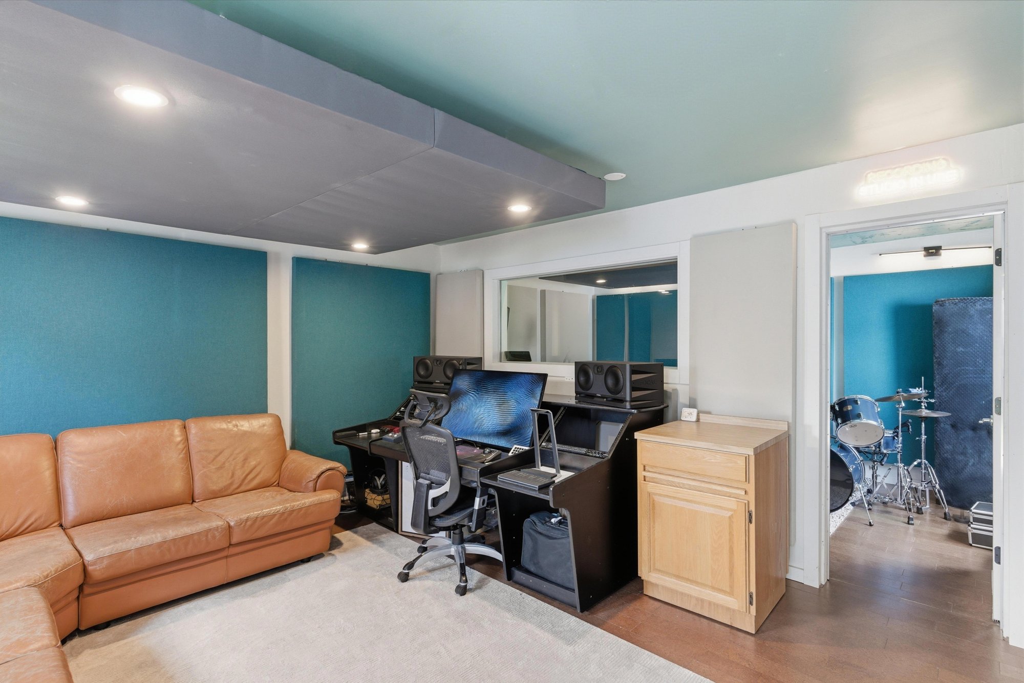 Control room with seating and a view into the recording room